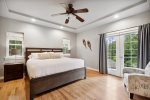 This room features balcony access & forested views  